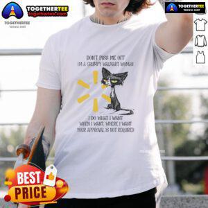 Grumpy woman wearing a Good Tired Cat t-shirt at Walmart, showcasing a humorous attitude with a playful cat graphic.