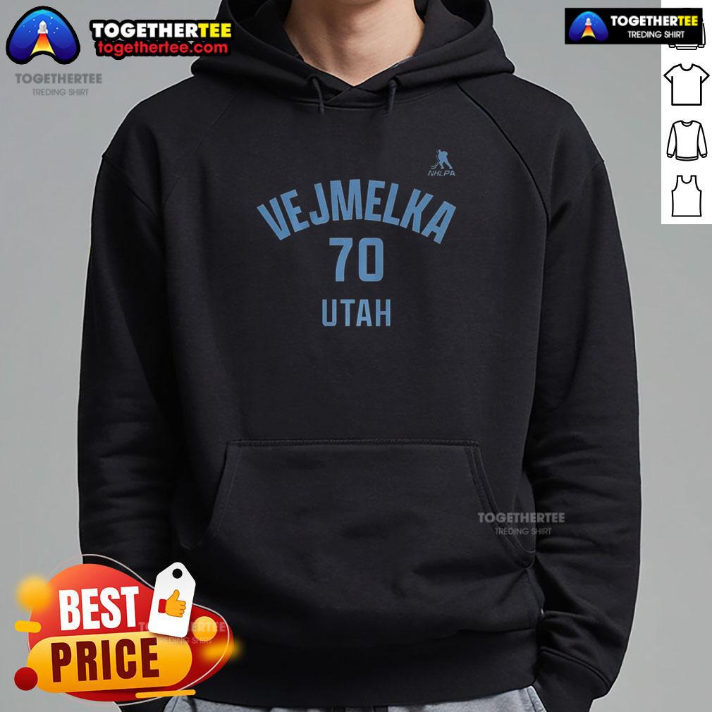 Happy Karel Vejmelka wearing Utah Mammoth hockey hoodie with name and number 70, showcasing team spirit and style.