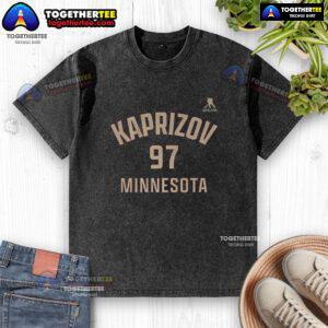 Alt Text: Happy Kirill Kaprizov wearing a Minnesota Wild 97 washed t-shirt, showcasing team spirit and style in ice hockey.