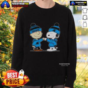 Alt Text: Cozy sweatshirt featuring Snoopy and Charlie Brown, perfect for Carolina Panthers fans and best friends.
