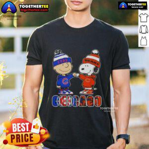 Official Charlie Brown fist bump with Snoopy on Chicago Cubs and Bears T-shirt, perfect for sports fans.