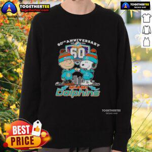 Alt Text: Original Charlie Brown fist bump with Snoopy on a Miami Dolphins skyline sweatshirt for the 60th anniversary (1965-2025).