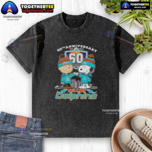 Alt Text: Original Charlie Brown fist bump with Snoopy on a Miami Dolphins skyline washed t-shirt, celebrating 60th anniversary.