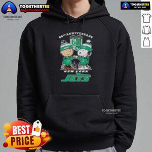 Alt Text: Original Charlie Brown fist bump with Snoopy, celebrating 66th anniversary, featuring New York Jets skyline on hoodie.