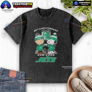 Original Charlie Brown fist bump with Snoopy graphic on a washed t-shirt, celebrating the 66th anniversary and New York Jets skyline.