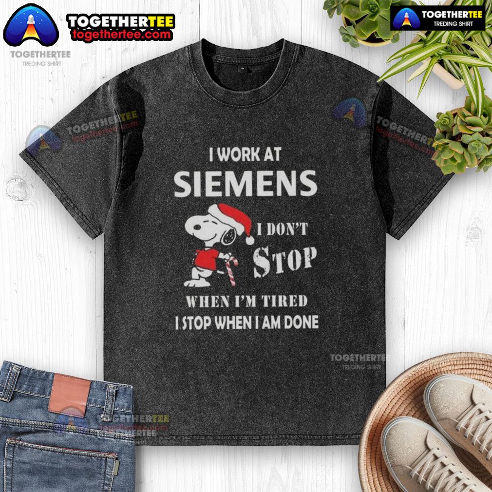 Alt Text: Funny Snoopy Christmas T-shirt with 'I Work At Siemens, I Dont Stop When Im Tired' slogan, perfect for holidays.