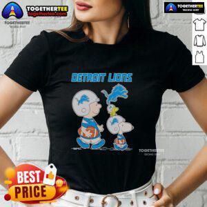 Detroit Lions ladies tee featuring Snoopy and Charlie Brown, perfect for fans of the NFL and the Detroit Lions.