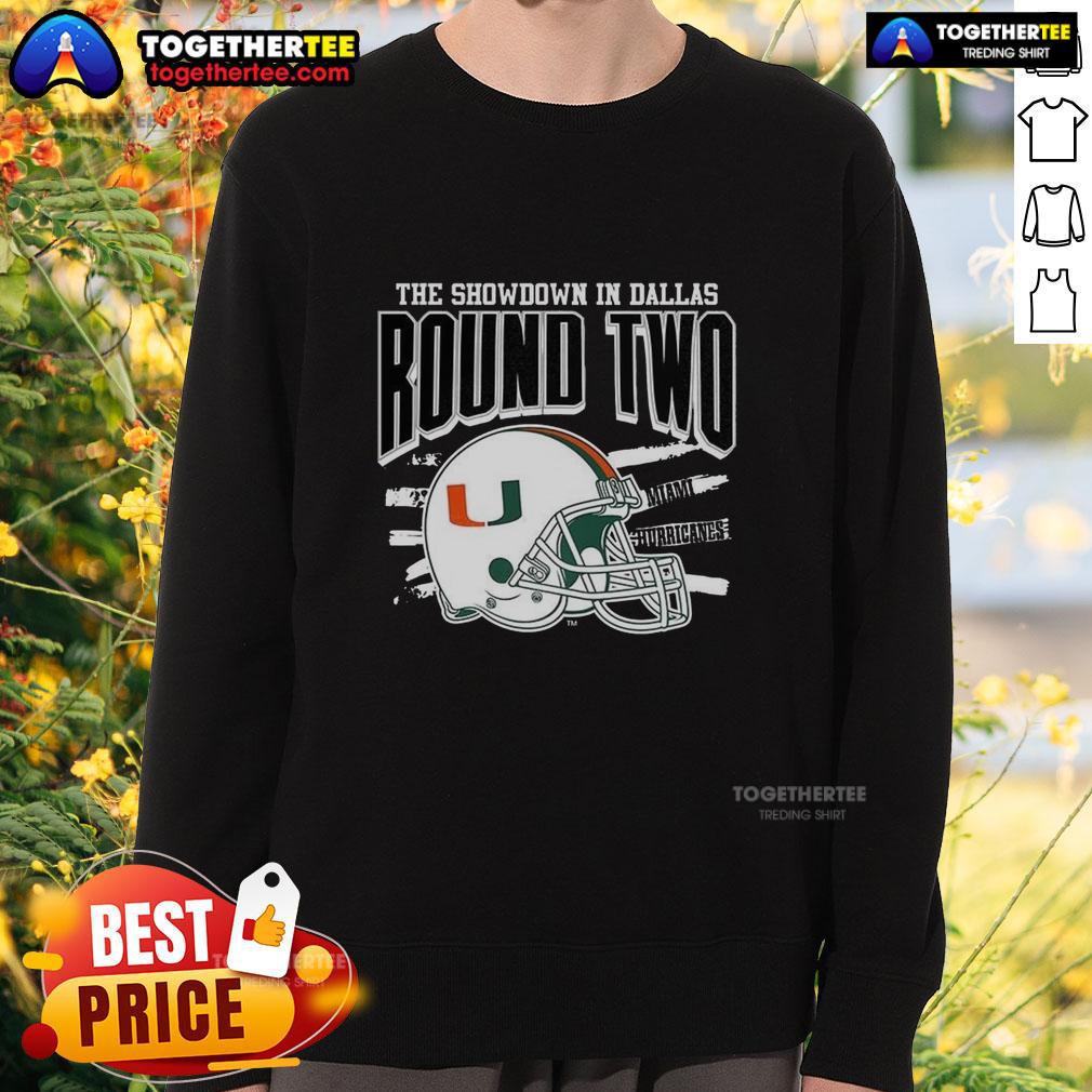 Alt Text: Official Miami Hurricanes NCAA CFP The Showdown in Dallas Round Two helmet sweatshirt, featuring team colors and logo.