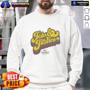 Alt Text: Black sweatshirt featuring the 'Good Jobs and Justice' logo, promoting social equity and fair employment opportunities.