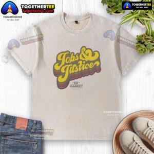 Good Jobs and Justice logo on a washed t-shirt, promoting fair labor practices and social equity.