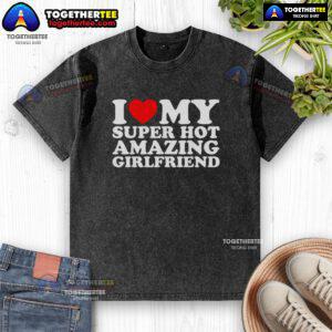Cute woman wearing a 'I Love My Super Amazing Girlfriend' washed T-shirt, smiling outdoors.