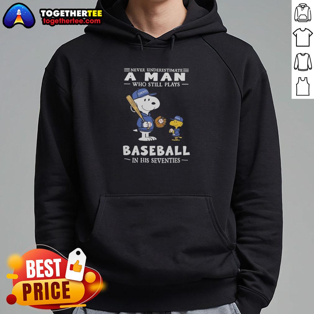 Stylish Nice The Peanuts X Toronto Blue Jays hoodie with 'Never Underestimate A Man Who Still Plays Baseball In His Seventies' slogan.