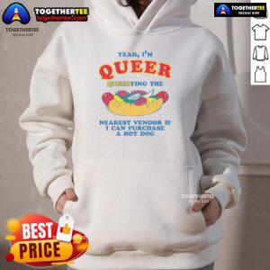 Person in a colorful hoodie asking a vendor about buying a hot dog, showcasing pride and inclusivity in a vibrant setting.