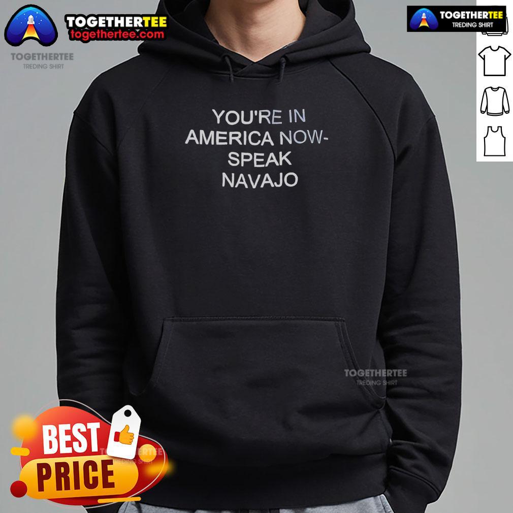 Official 'Youre In America Now, Speak Navajo' hoodie featuring bold text design, perfect for cultural pride and style.