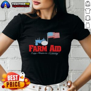 Alt Text: Premium Farm Aid Keep America Growing logo featuring a tractor and American flag on a ladies tee shirt.