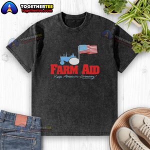 Alt Text: Premium Farm Aid Keep America Growing logo featuring a tractor and American flag on a washed t-shirt.