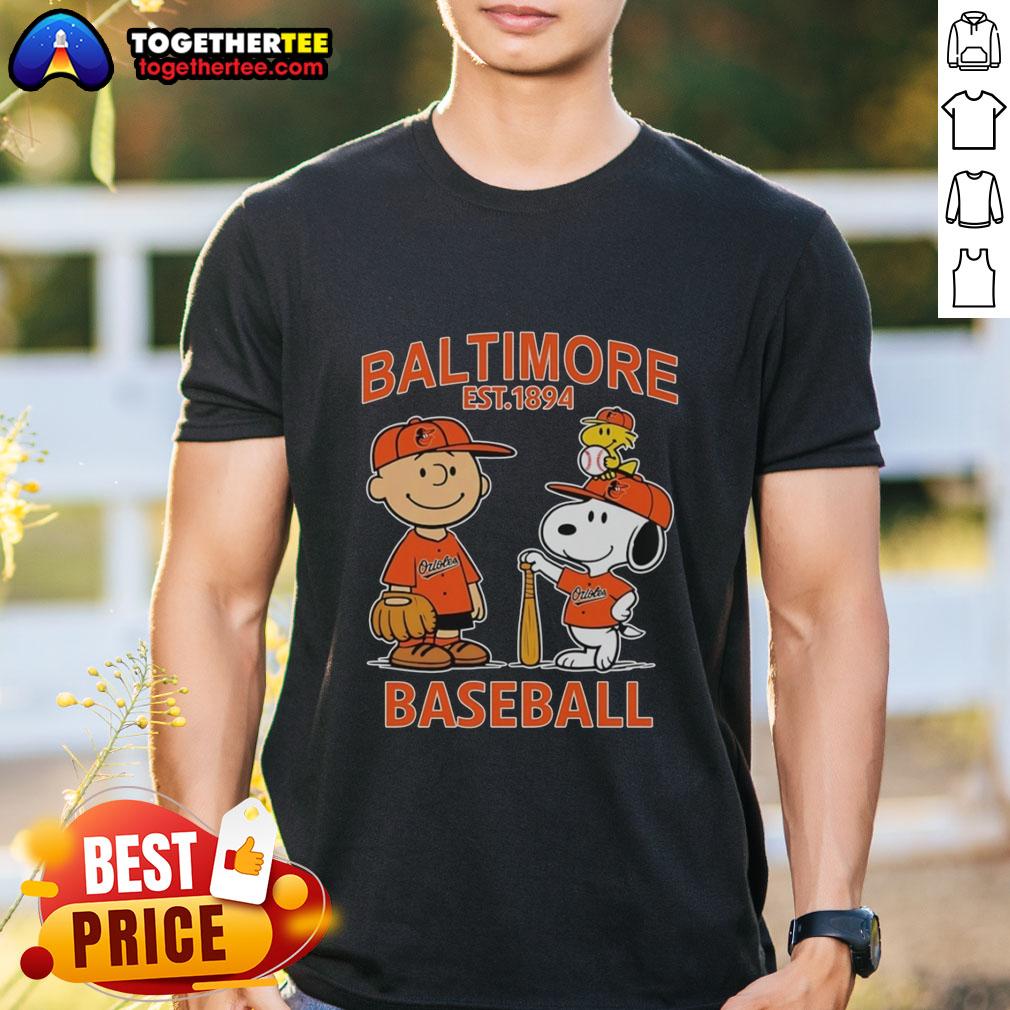 Charlie Brown, Snoopy, and Woodstock wearing Baltimore Orioles jersey on a fun t-shirt, celebrating the team's legacy since 1894.
